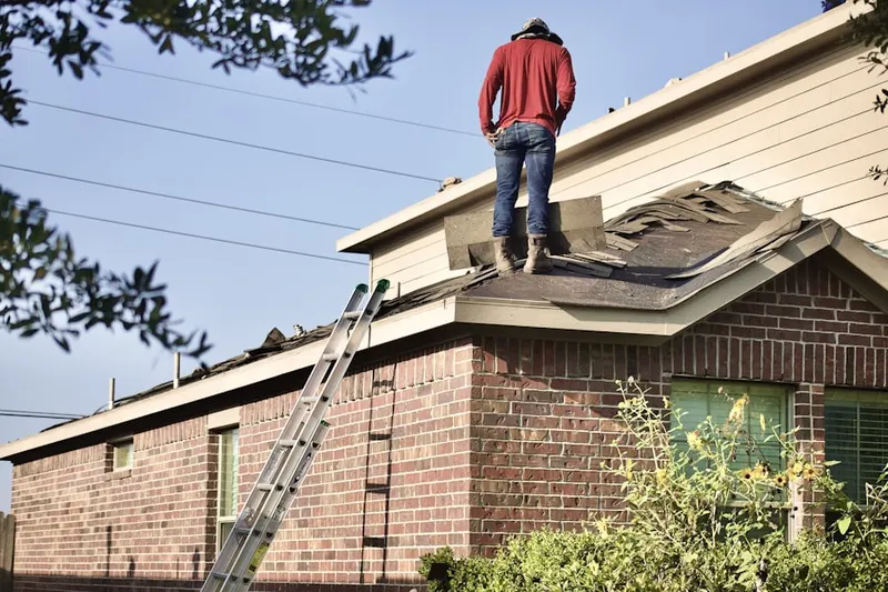 Professional roofer working on a residential roof in Paris Court West